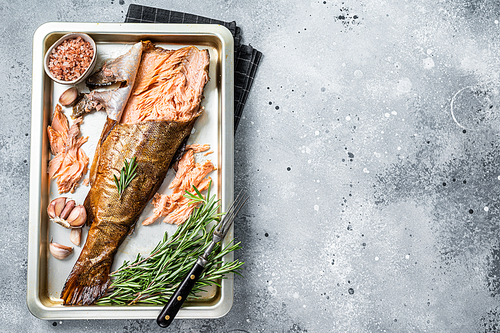 Hot smoked salmon,  trout fish with herbs. Gray background. Top view. Copy space.