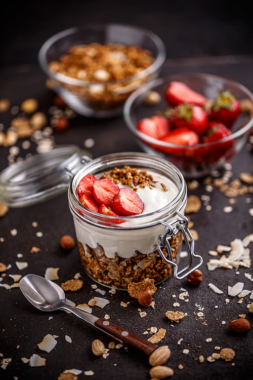 Healthy breakfast concept. Granola or muesli with yogurt and fresh strawberries.