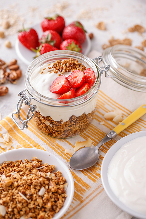 Ingredients for healthy breakfast: granola,yogurt and strawberries