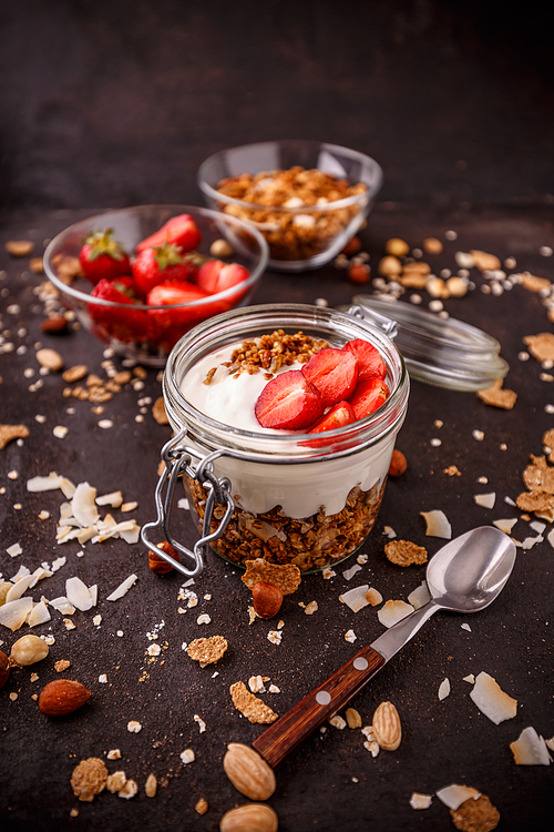 Ingredients for healthy breakfast: granola,yogurt and strawberries