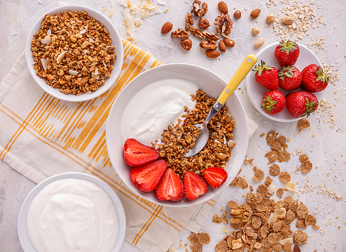 Crunchy granola or muesli with yogurt and fresh strawberries