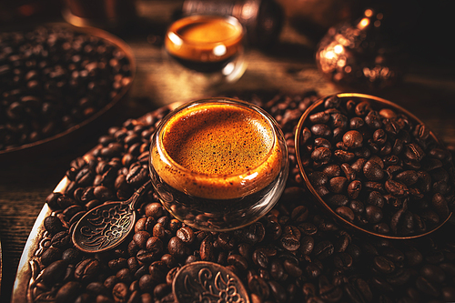 Hot freshly brewed espresso coffee in a double walled shot glasses