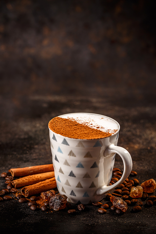 Coffee latte decorated with cinnamon powder, copy space