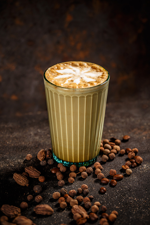 Winter warm spice coffee drink on vintage dark background