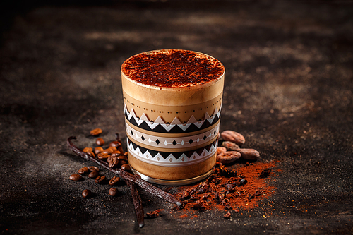 Сup of coffee with vanilla and cocoa on a vintage dark background