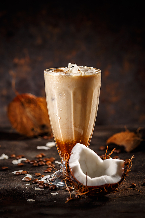 Coffee with coconut milk on dark background