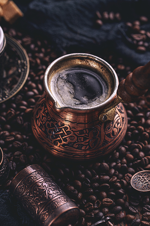 Close up of hot coffee in Turkish cooper and coffee beans