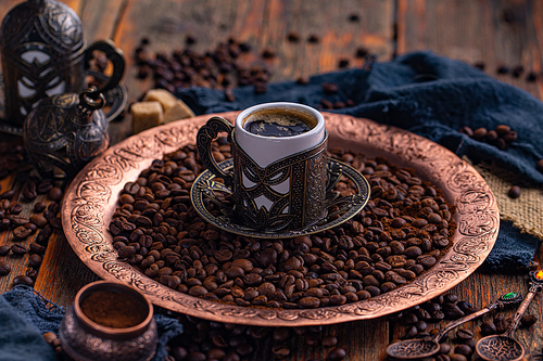 Cup of Turkish coffee with baklava on metal oriental tray