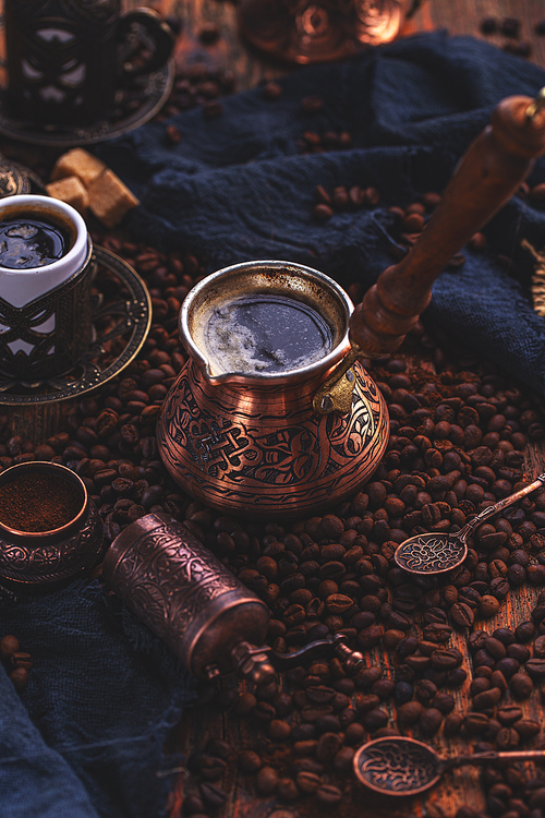 Turkish copper coffee pot (Cezve), vintage coffee grinder, cup and coffee beans