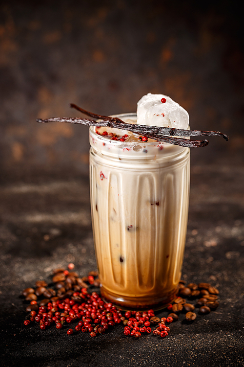 Tall glass coffee latte with pink peppercorn and vanilla