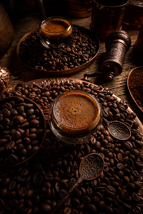 Glass cup with espresso coffee on coffee beans background