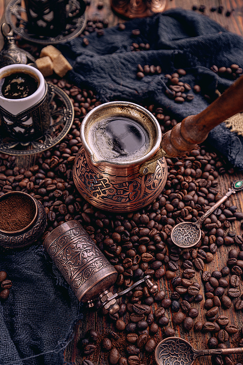 Turkish coffee pot with roasted coffee beans. Still life