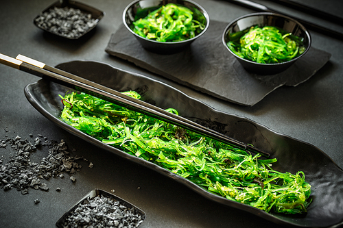 A delicious fresh seaweed salad on black background