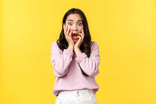 Lifestyle, emotions and advertisement concept. Shocked and scared asian girl in awe, drop jaw and stare camera terrified over disaster, bad awful news, widen eyes at camera surprised.