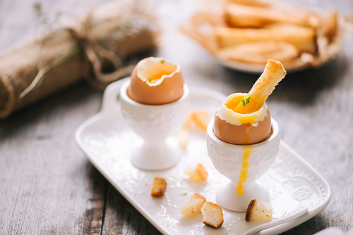 delicious breakfast with boiled eggs and crispy toasts, horizontal, closeup