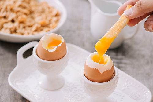 delicious breakfast with boiled eggs and crispy toasts, horizontal, closeup