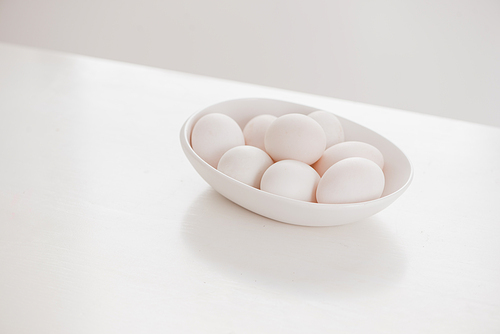 Eggs on white plate on wooden table