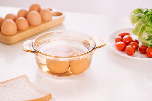 Healthy breakfast consisting of toast, eggs, salad, tomato