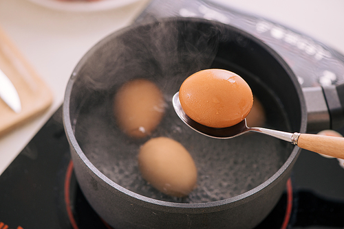 Chef putting boiled eggs in cup / Cooking sweet brown Stewed pork gravy (Moo Pa-lo) concept