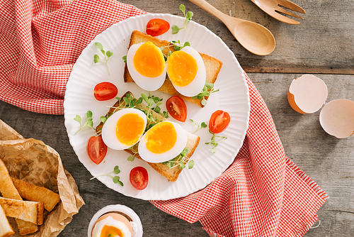 freshly boiled white egg on wooden board. Healthy fitness breakfast.
