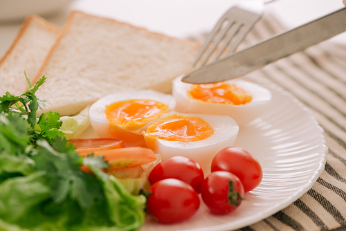 Healthy breakfast or lunch. Poached egg with tomato and whole toast. Selective focus. Healthy eating, healthy lifestyle concept