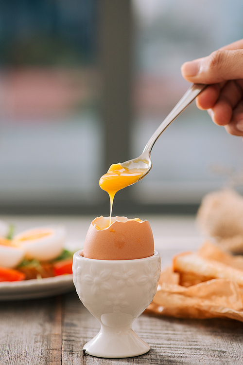 freshly boiled white egg on wooden board. Healthy fitness breakfast.