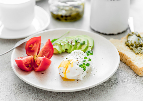 healthy breakfast: poached eggs, vegetables and tea