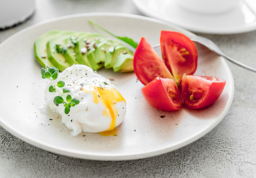 healthy breakfast: poached eggs, vegetables and tea