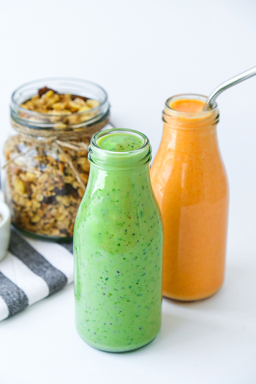 Seasonal Matcha green vegan smoothie with chia seeds and mint pumpkin carrot smoothie drink detox Glass jar granola muesli oatmeal breakfast. Clean eating, weight loss, healthy dieting food concept Fruit vegetable drink fitness