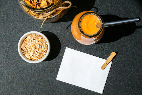 Seasonal pumpkin carrot smoothie drink detox with eco metal drinking straw Glass jar granola muesli oatmeal breakfast. Paper note. Clean eating, weight loss, healthy dieting food concept Fruit vegetable drink fitness