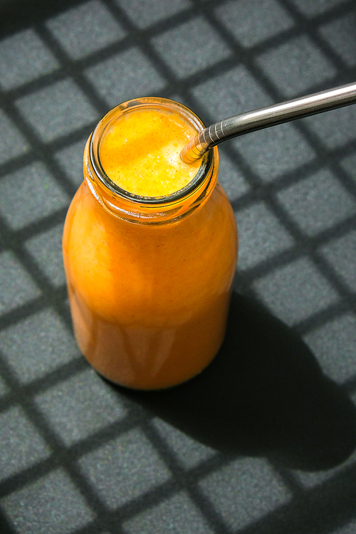 Seasonal pumpkin carrot smoothie drink detox Breakfast. Clean eating, weight loss, healthy dieting food concept Fruit vegetable drink fitness. Trendy shadows