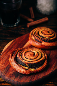 Sweet roll with poppy seeds. Glass of black coffee