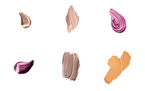 Set of art brush strokes or cosmetic makeup samples isolated on white background.