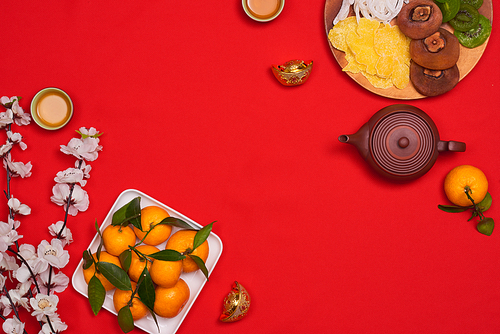 Vietnamese food for Vietnam Tet holiday, also lunar new year of Asia, colorful preserved fruit as kiwi, damson jam, or coconut jam set up on white plate with green wood background make art