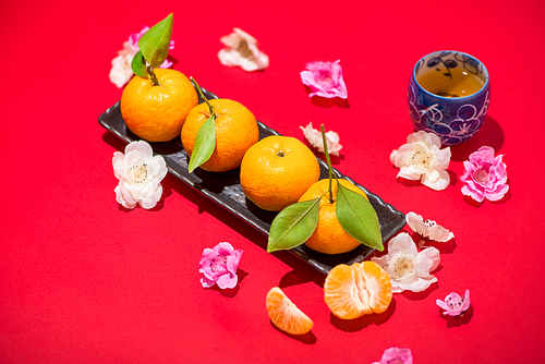 Chinese new year's decoration. Mandarin orange on red background.