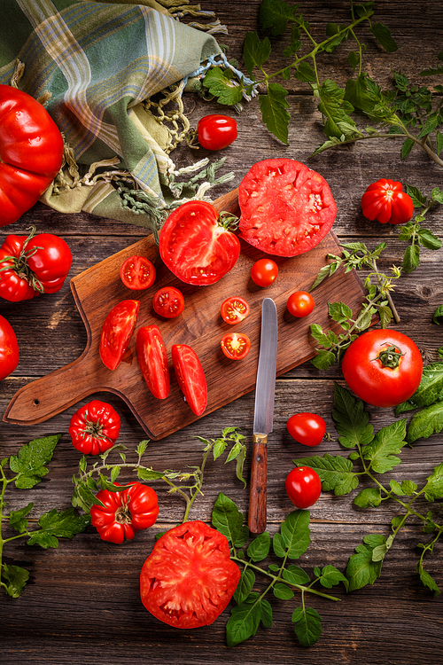 Fresh sliced tomatoes on wooden background
