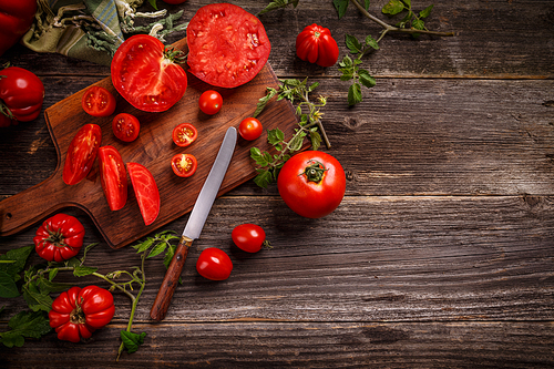 Flat lay composition with juicy tomatoes on wooden background