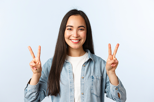 Lifestyle, people emotions and beauty concept. Friendly optimistic kawaii girl, asian female student in casual outfit showing v-sign, peace gesture over white background.