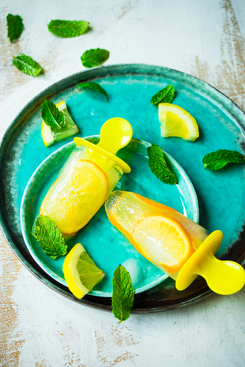 Summer dessert with lemon and mint on rustic wooden background with copyspace