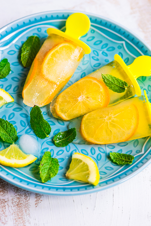 Summer dessert with lemon and mint on rustic wooden background with copyspace