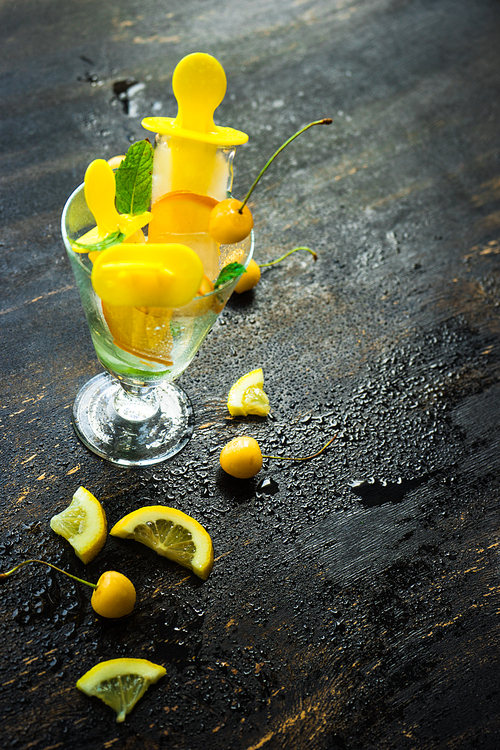 Summer dessert with lemon and mint on rustic wooden background with copyspace