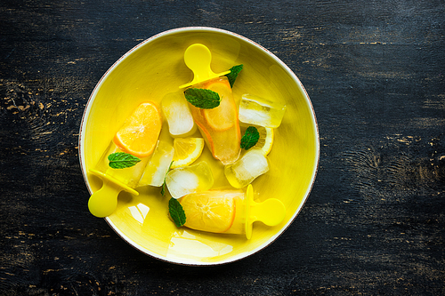 Summer dessert with lemon and mint on rustic wooden background with copyspace