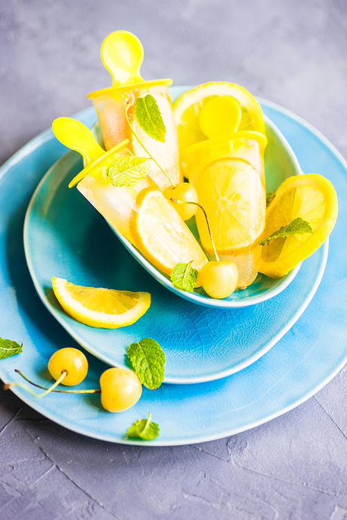 Summer dessert with lemon and mint on rustic wooden background with copyspace