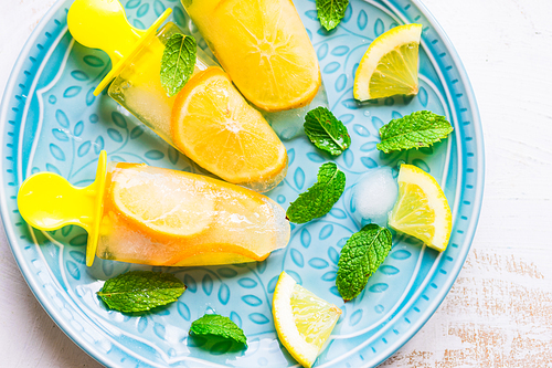 Summer dessert with lemon and mint on rustic wooden background with copyspace