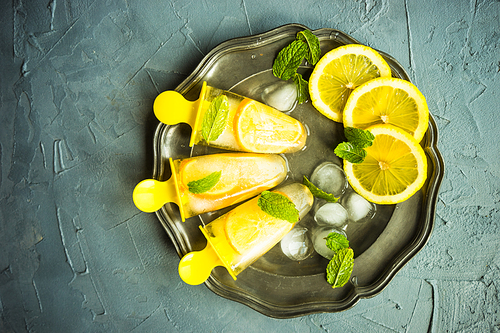 Summer dessert with lemon and mint on rustic wooden background with copyspace