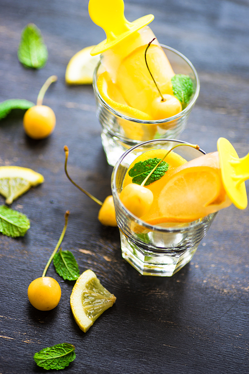 Summer dessert with lemon and mint on rustic wooden background with copyspace