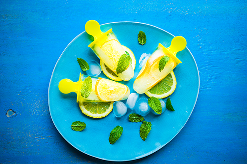 Summer dessert with lemon and mint on rustic wooden background with copyspace