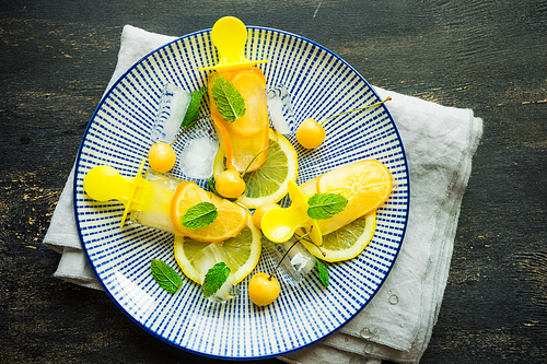 Summer dessert with lemon and mint on rustic wooden background with copyspace