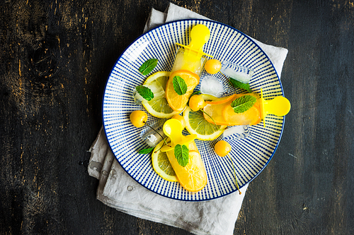 Summer dessert with lemon and mint on rustic wooden background with copyspace