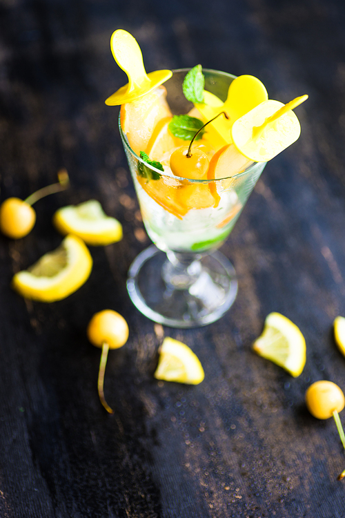 Summer dessert with lemon and mint on rustic wooden background with copyspace